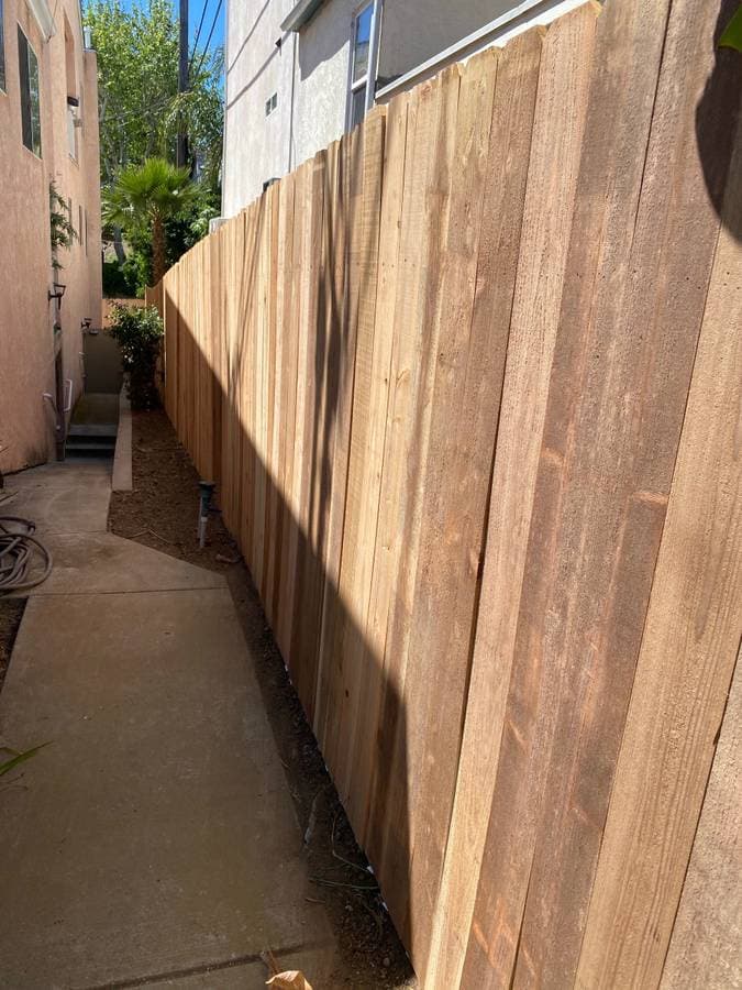 newly installed wood fence in between homes