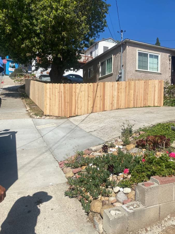 newly installed front yard  shoulder high wood fence 