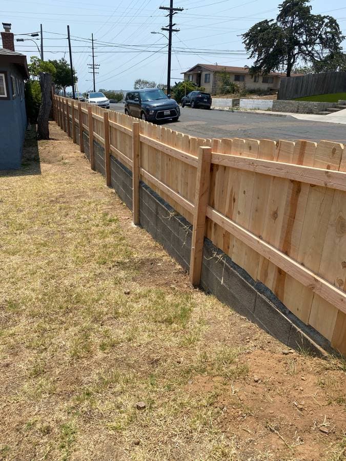 newly installed wooden fence and concrete barrier