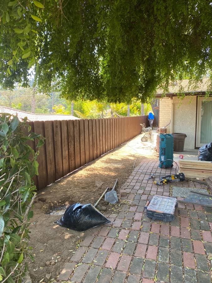 newly installed wooden fence in the backyard of a home