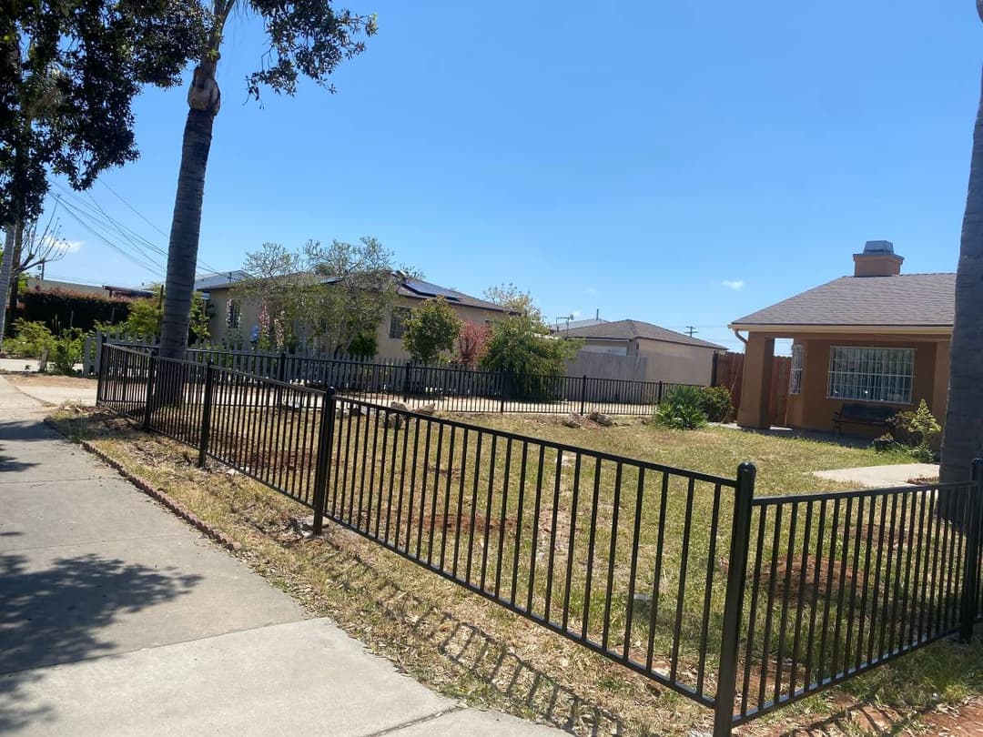 picture of a freshly installed black steel front yard fence