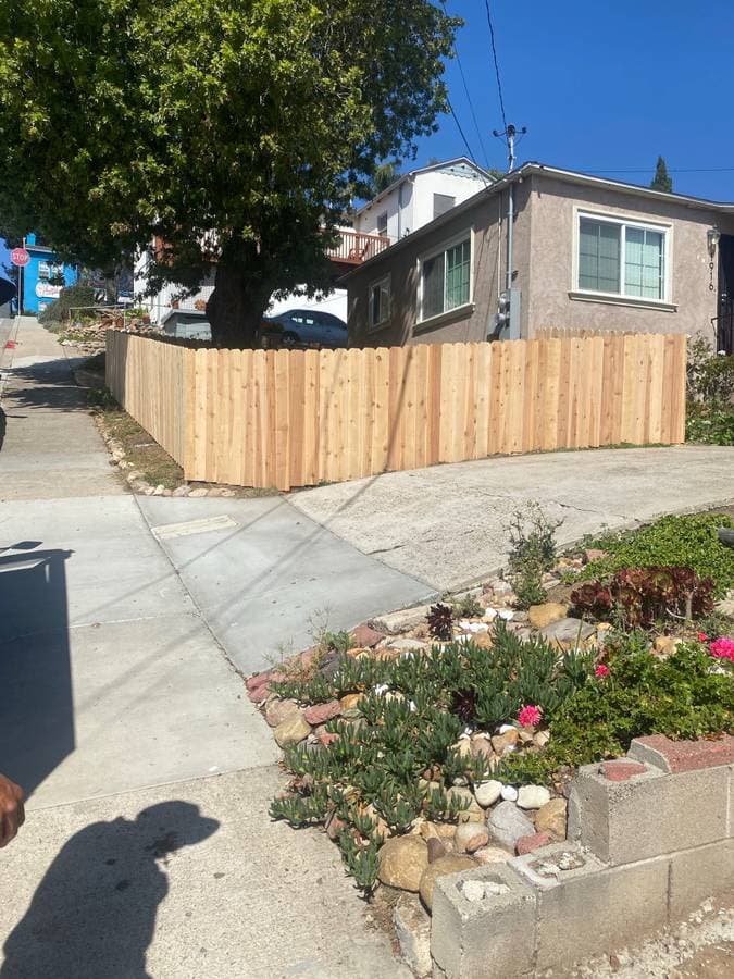 newly installed front yard shoulder high wood fence
